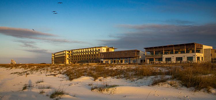 The Lodge at Gulf State Park with beach in front of it